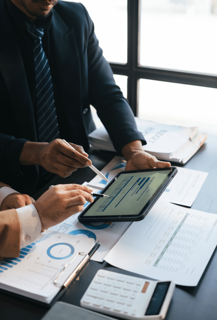 " people with a tablet showing graphs